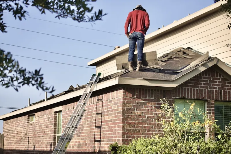 Professional roofer working on a residential roof in Narragansett
